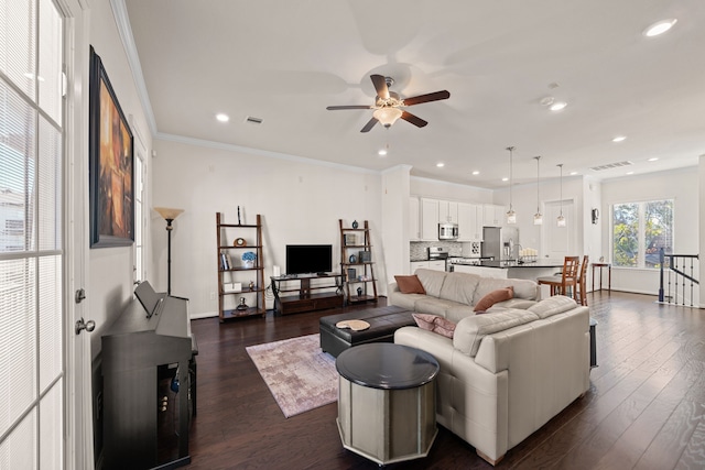 living area featuring recessed lighting, dark wood finished floors, visible vents, and crown molding