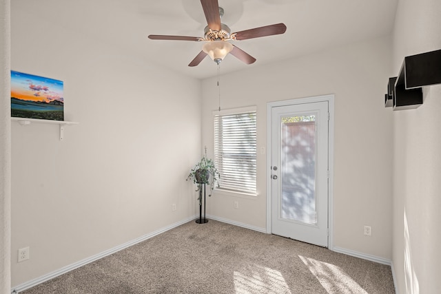 entryway with light carpet, ceiling fan, and baseboards