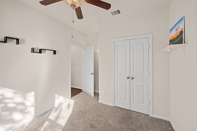 unfurnished bedroom with ceiling fan, visible vents, baseboards, a closet, and carpet