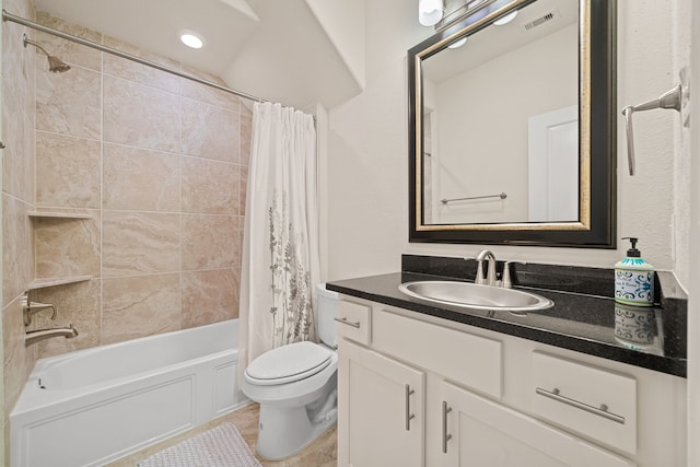 bathroom with toilet, shower / tub combo, visible vents, and vanity