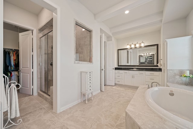 full bathroom featuring a walk in closet, a shower stall, vanity, and a bath