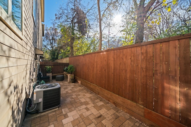 view of patio / terrace featuring a fenced backyard and central air condition unit