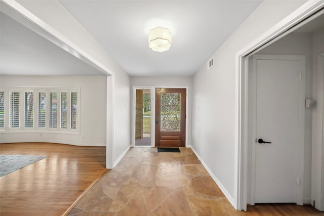 entrance foyer with light wood-type flooring, visible vents, plenty of natural light, and baseboards