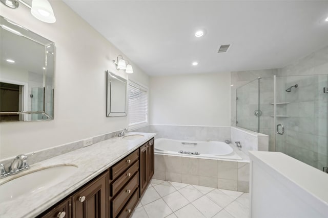 full bathroom with a garden tub, a sink, a shower stall, and tile patterned floors