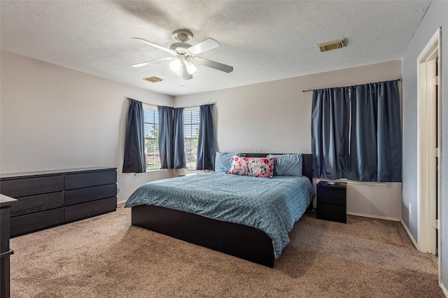 carpeted bedroom with baseboards, visible vents, and ceiling fan