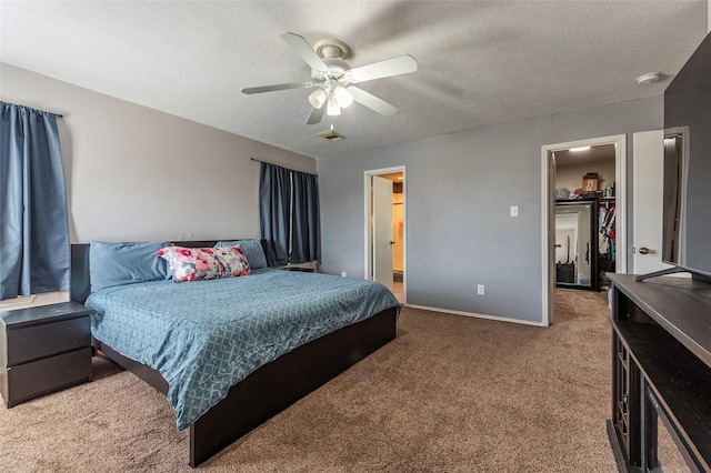 carpeted bedroom featuring baseboards, visible vents, ceiling fan, a spacious closet, and a textured ceiling