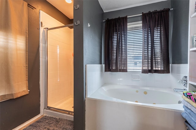 full bathroom featuring a garden tub and a shower stall