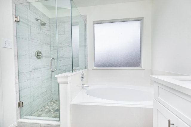 bathroom with vanity, a shower stall, and a bath