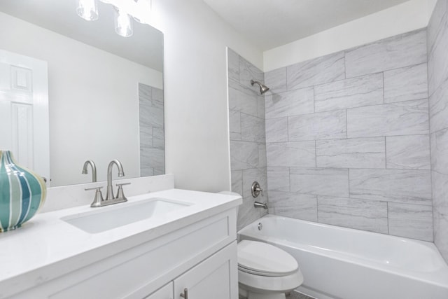 bathroom featuring vanity, bathtub / shower combination, and toilet