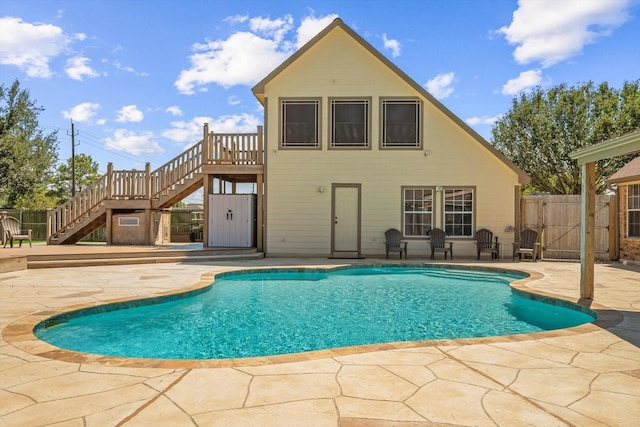 view of swimming pool featuring a fenced in pool, a patio area, and stairs