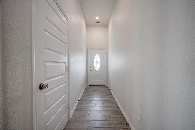 24690 Galway St, Hempstead, TX 77445 - doorway with a textured wall, wood finish floors, visible vents, and baseboards