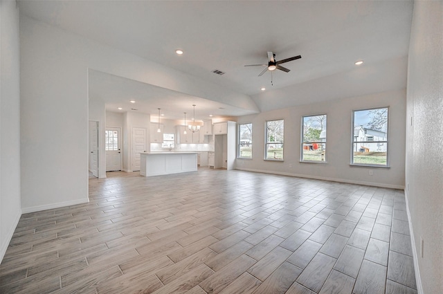 24690 Galway St, Hempstead, TX 77445 - unfurnished living room featuring ceiling fan with notable chandelier, light wood-type flooring, plenty of natural light, and visible vents