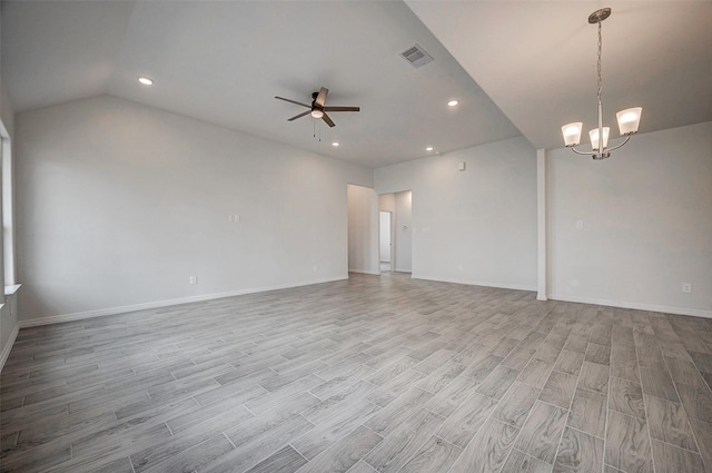 24690 Galway St, Hempstead, TX 77445 - empty room with light wood-type flooring, lofted ceiling, visible vents, and ceiling fan with notable chandelier