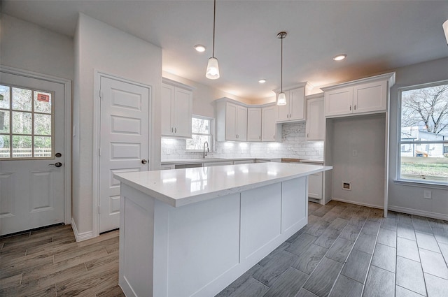 24690 Galway St, Hempstead, TX 77445 - kitchen featuring a sink, light countertops, a center island, and white cabinets