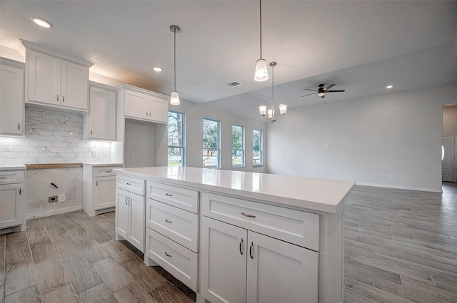24690 Galway St, Hempstead, TX 77445 - kitchen featuring pendant lighting, light countertops, visible vents, and white cabinets