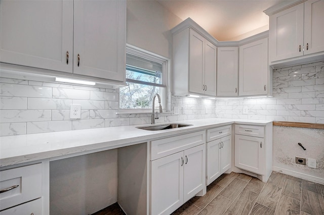24690 Galway St, Hempstead, TX 77445 - kitchen with a sink, white cabinets, light countertops, light wood finished floors, and tasteful backsplash