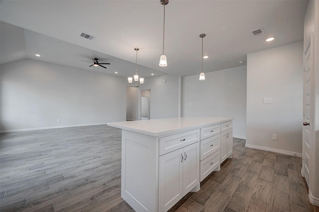 24690 Galway St, Hempstead, TX 77445 - kitchen with light countertops, white cabinets, visible vents, and open floor plan