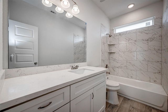 24690 Galway St, Hempstead, TX 77445 - full bathroom with visible vents, shower / bathing tub combination, toilet, vanity, and wood finished floors
