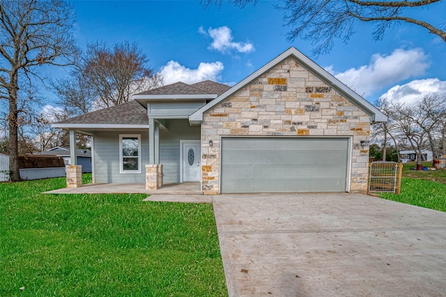 view of front of property with a shingled roof, a front yard, a garage, stone siding, and driveway