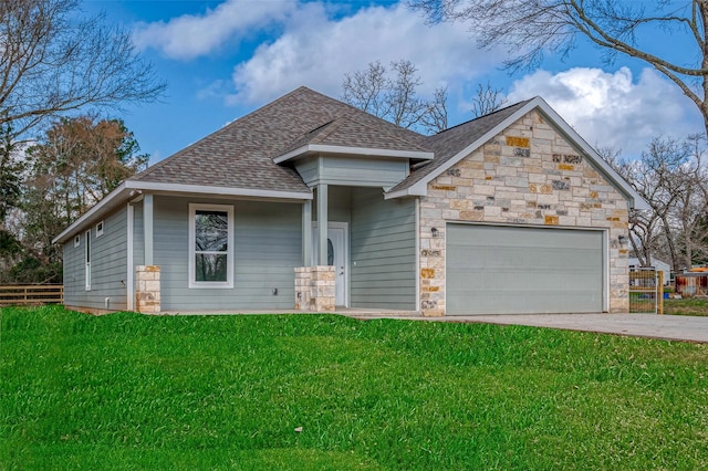 view of front facade featuring a shingled roof, concrete driveway, stone siding, an attached garage, and a front yard