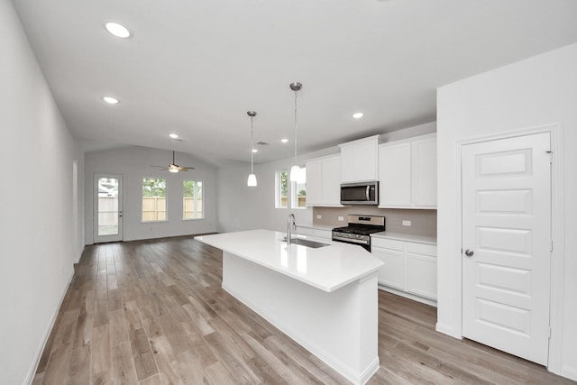 24727 Harrow Meadow Dr, Katy, TX 77493 - kitchen featuring light countertops, white cabinetry, light wood-style floors, stainless steel appliances, and a sink