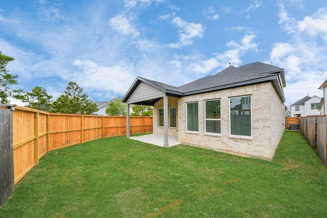 24727 Harrow Meadow Dr, Katy, TX 77493 - back of property with brick siding, a yard, a patio, and a fenced backyard