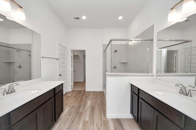 24727 Harrow Meadow Dr, Katy, TX 77493 - bathroom with a sink, visible vents, a stall shower, and wood finished floors