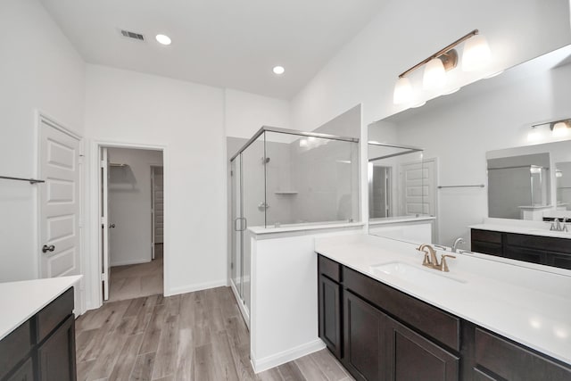 24727 Harrow Meadow Dr, Katy, TX 77493 - full bathroom featuring a sink, visible vents, a shower stall, and wood finished floors