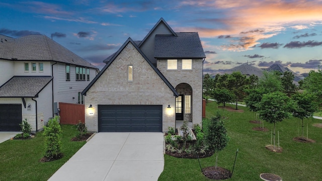 24727 Harrow Meadow Dr, Katy, TX 77493 - french provincial home featuring a yard, concrete driveway, a garage, and brick siding