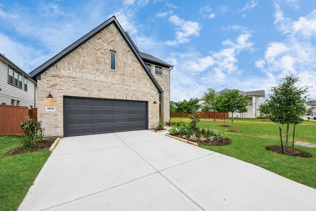24727 Harrow Meadow Dr, Katy, TX 77493 - view of front facade featuring brick siding, driveway, fence, and a front lawn