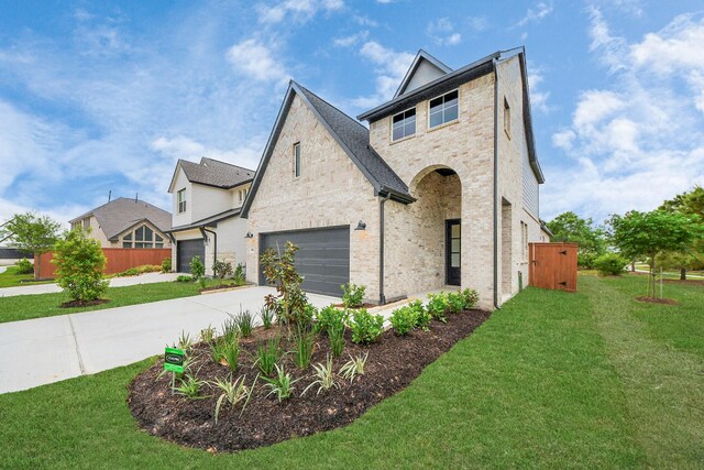 24727 Harrow Meadow Dr, Katy, TX 77493 - view of front of house with driveway, a front yard, fence, and brick siding