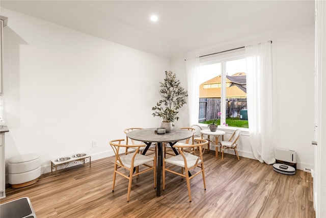 dining room with recessed lighting, breakfast area, light wood-type flooring, and baseboards