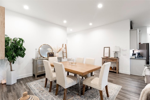 dining area featuring dark wood-type flooring, recessed lighting, and baseboards