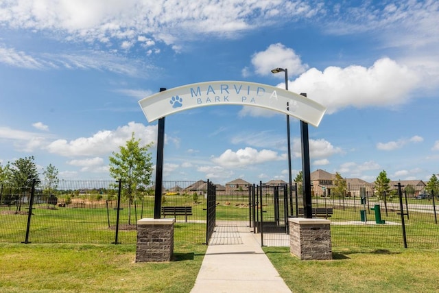 view of community with a lawn and fence