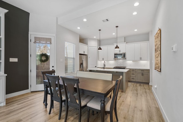 dining area with light wood-style flooring, visible vents, baseboards, and recessed lighting