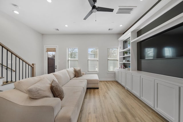 living area with light wood-type flooring, stairs, visible vents, and recessed lighting