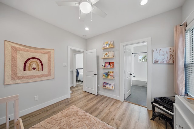 interior space with ceiling fan, recessed lighting, baseboards, light wood finished floors, and ensuite bath