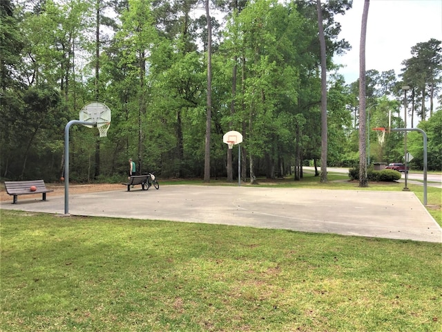 view of basketball court featuring community basketball court and a yard