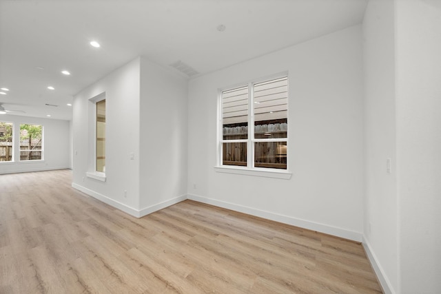 empty room with baseboards, ceiling fan, recessed lighting, and light wood-style floors