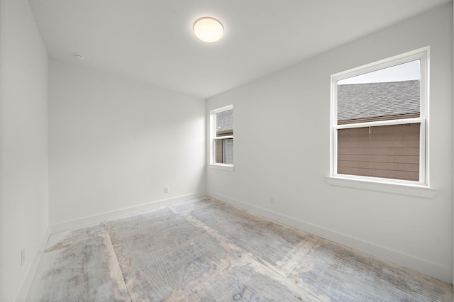 spare room featuring baseboards