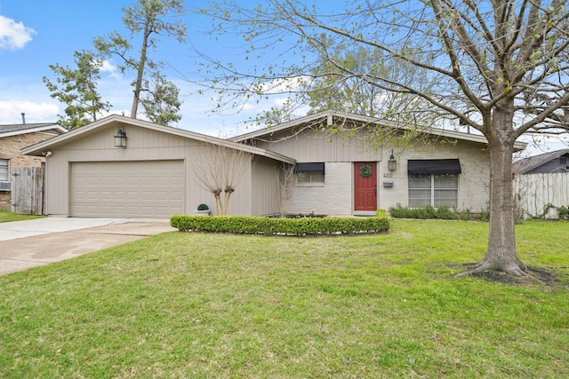 view of front facade with a garage, concrete driveway, brick siding, and a front yard