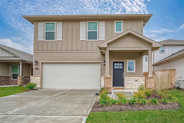 craftsman house featuring a garage, stone siding, board and batten siding, and driveway