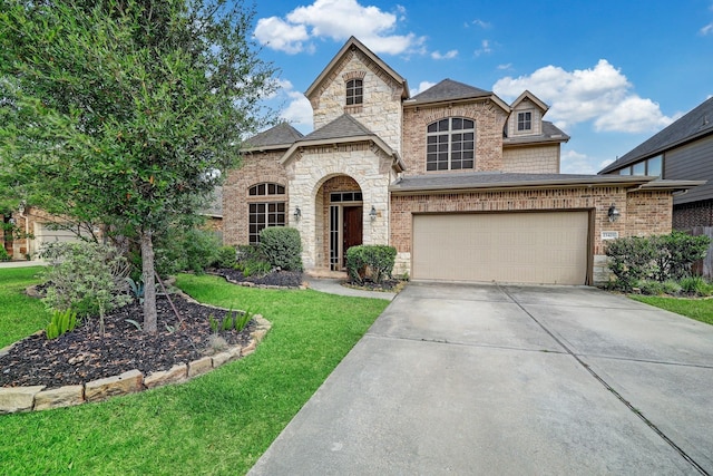 french country inspired facade featuring brick siding, a front lawn, concrete driveway, a garage, and stone siding