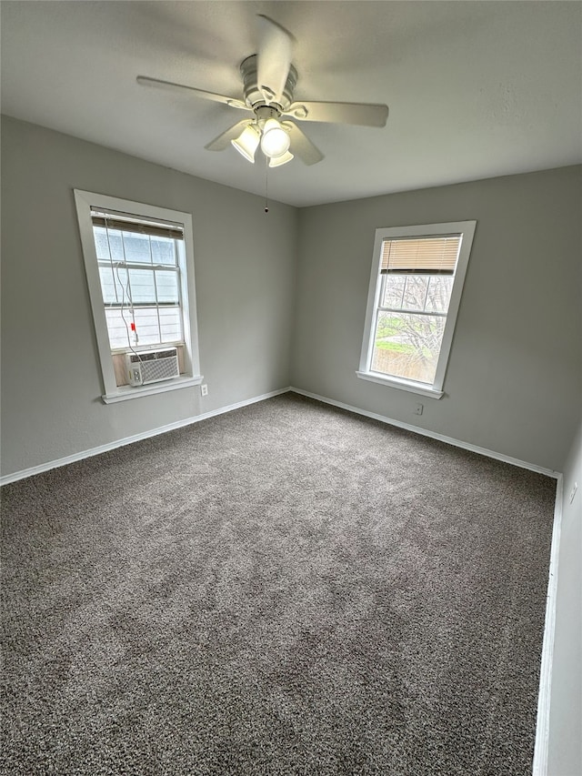 empty room with carpet floors, plenty of natural light, and baseboards