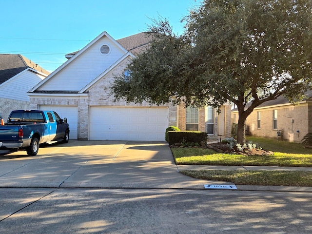 view of front of house with concrete driveway, brick siding, and an attached garage