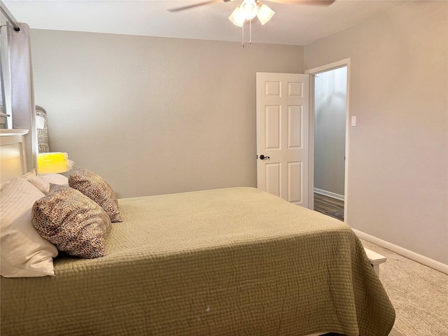 bedroom with a ceiling fan, baseboards, and carpet flooring