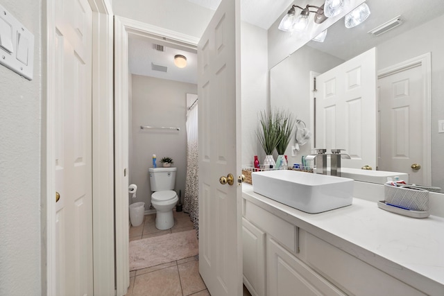 full bathroom with toilet, tile patterned flooring, visible vents, and vanity