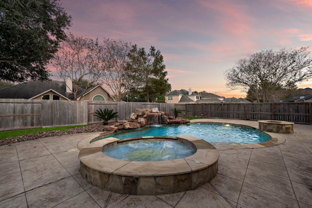 view of pool featuring a pool with connected hot tub, a fenced backyard, and a patio