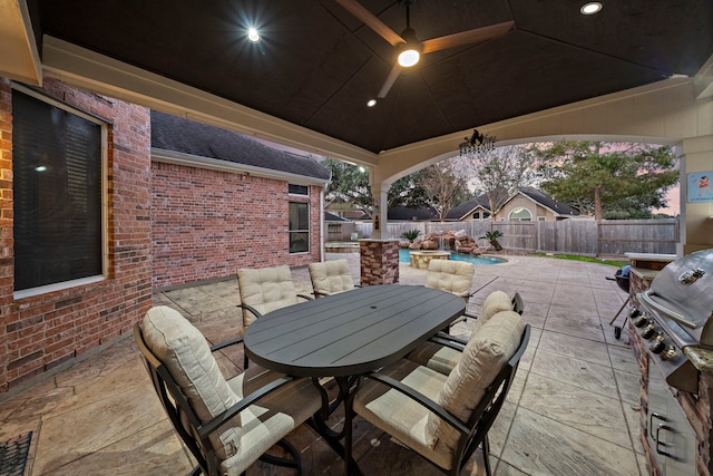 view of patio with outdoor dining area, a fenced backyard, a fenced in pool, and a ceiling fan