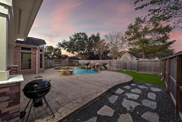 pool at dusk featuring a patio, a fenced backyard, an in ground hot tub, grilling area, and a fenced in pool